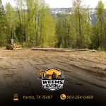 Lake Fork News A professional land-clearing scene unfolds near Sulphur Springs, Texas, where a yellow construction vehicle is stationed among substantial felled logs in a freshly cleared forest area. The image highlights the scale and organization of the operation within the East Texas landscape. Along the bottom edge, Weems Heavenly Acres’ logo appears alongside their Yantis, TX location and contact number—(903) 254-0469—providing clear business identification. Lake Fork, TX
