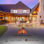 Lake Fork News An inviting, elegantly illuminated backyard patio in Dallas features a spacious stone firepit surrounded by upscale custom outdoor living amenities. The scene spotlights a sophisticated wood-and-stone residence aglow in the golden light of sunset, epitomizing luxury suburban living. At the base of the image, branding for “Suburban Oasis”—complete with logo, contact information, and specific Dallas location details—offers interested viewers immediate access to this sought-after locale. Lake Fork, TX