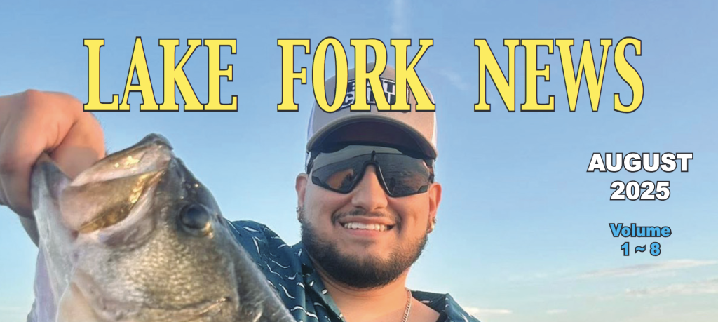 Lake Fork News A man wearing dark sunglasses and a blue cap grins broadly as he proudly holds up an impressive largemouth bass, showcasing his catch for the camera. Behind him, the clear Texas sky stretches over Lake Fork, a renowned fishing destination. Superimposed at the top are bold white headlines: "LAKE FORK NEWS," "August 2025 Online Edition," and "Volume 1 ~ 8," emphasizing the local news publication’s latest issue against the vivid blue backdrop. Lake Fork, TX