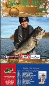 Lake Fork News On Lake Fork’s shore, a smiling angler in black cap and jacket displays a large fish on Lake Fork News’ Dec 2025 Christmas cover. Lake Fork, TX